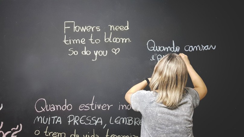 someone writing on a blackboard during class