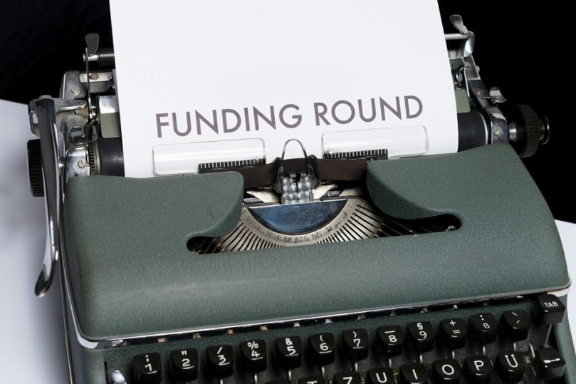 Typewriter with sheet of paper saying 'FUNDING ROUND'